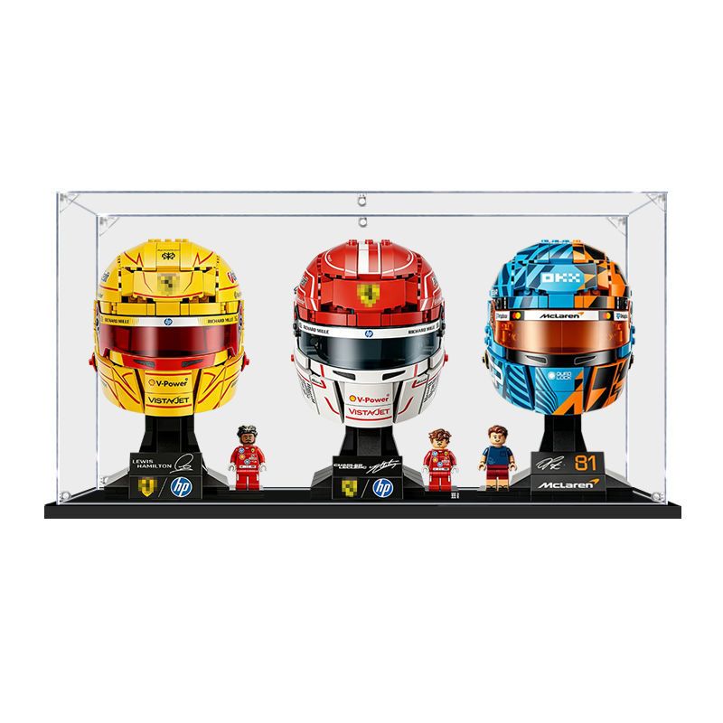 Acrylic display case holding three LEGO Formula 1 helmets side by side